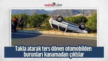 Takla atarak ters dönen otomobilden burunları kanamadan çıktılar